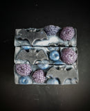 Blue and purple blue berry infused soap with berry and bat motif on top.