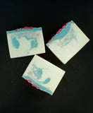 Twisted Cherry Blossom soap. White soap with blue swirl and pink sprinkles with red soap blossoms on top