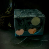 Samhain artisan soap. Grey and black swirl soap with full moon and pumpkin embeds.