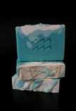 Blue soap with white top and eco glittter. Aquarius symbol stamped on front.