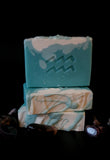 Blue soap with white top and eco glittter. Aquarius symbol stamped on front.