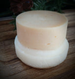 White solid shampoo bar pictured with  the complimentary conditioner bar