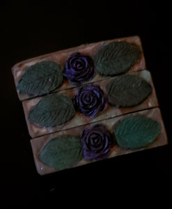 Dark Purple soap bar with gree and lavender swirls, topped with a dark purple soap rose and green soap leaves