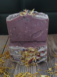 Purple soap with speckles and botanicals on top