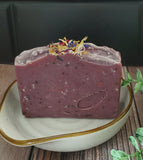 Purple soap with speckles and botanicals on top