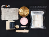 Summer Solstice Celebration Box includes calendula infused soap, sisal soap bag. Celestial citrus shower steamers, strawberry maxi tealight, honey lip balm, palo santo stick, citrine tumble & gold altar bowl