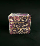 Three stacked soap bars with decorative patterns on a black background