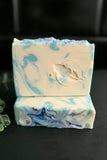 Marbled blue and white soap bar on a dark background