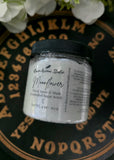 Jar of 'Moonflower' sugar scrub with a black lid on a decorative background