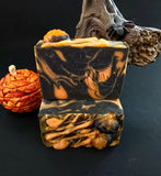 Two bars of soap with a Halloween theme on a dark background