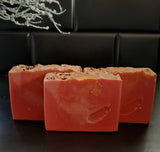Cranberry artisan soap with gold swirls and cranberry seed and jojoba beads on top