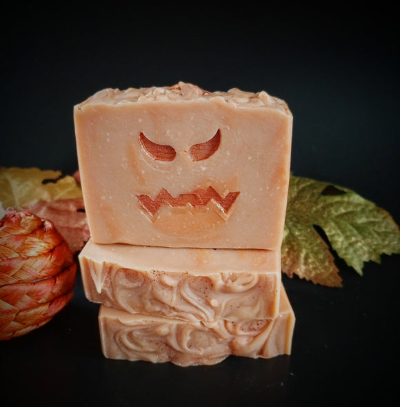 Pumpkin infused artisan soap, orange swirl soap bar with stamped  jack o lantern face