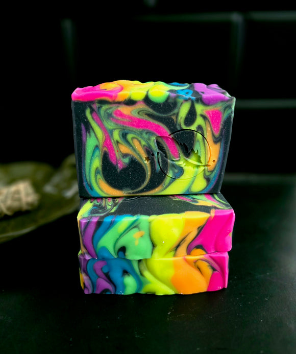 Neon rainbow colored swirls in  black soap bar.