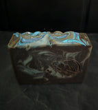 Soap bar in dark purple and silver accents on a black background.