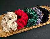 Crochet hair ties in a wooden dish