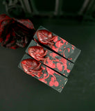Red and black soap bars with anatomical heart design on a dark background