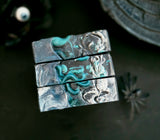  Black and blue soap stacked on a dark background