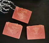 Cranberry artisan soap with gold swirls and cranberry seed and jojoba beads on top