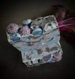 Blue and purple blueberry infused soap with berry and bat motif on top.
