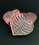 Heart shaped soap with rib cage design in black and pink colors on a dark background