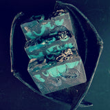  black and blue soap stacked on a dark background