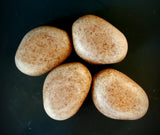 Gardener's Stone scrubbing soap. Tan stone in a rock shape.