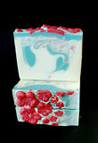 Twisted Cherry Blossom soap. White soap with blue swirl and pink sprinkles with red soap blossoms on top