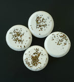 light green hemp seed oil bath bomb with herbs on top