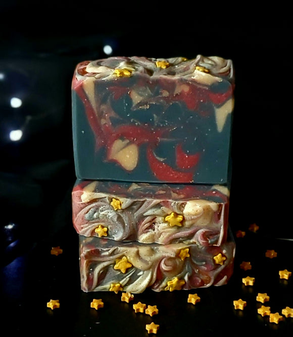Ringmaster Artisan soap. Navy, red and gold swirled soap with gold star sprinkles on top.