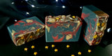 Ringmaster Artisan soap. Navy, red and gold swirled soap with gold star sprinkles on top.