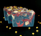 Ringmaster Artisan soap. Navy, red and gold swirled soap with gold star sprinkles on top.