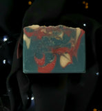 Ringmaster Artisan soap. Navy, red and gold swirled soap with gold star sprinkles on top.