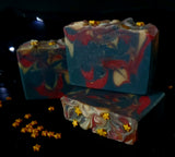 Ringmaster Artisan soap. Navy, red and gold swirled soap with gold star sprinkles on top.