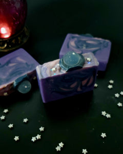 Oracle goat milk soap. Purple soap bar with navy and pink swirls. Clear crystal soap ball on top with silver star sprinkles