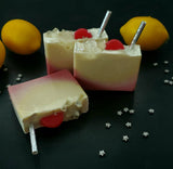 Lunar Lemonade Soap. Red and Yellow ombre with soap pink lemon slices and clear, sparkly stars. Removeable silver glittery straw on top.