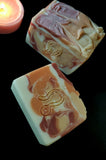 Leo Astrology Soap. White, red, gold and orange swirl soap with stamped Leo astrology sign on front.