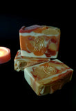 Leo Astrology Soap. White, red, gold and orange swirl soap with stamped Leo astrology sign on front.