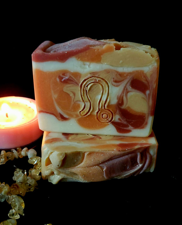 Leo Astrology Soap. White, red, gold and orange swirl soap with stamped Leo astrology sign on front.