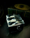 The Raven artisan soap. Black soap with white swirl and black soap raven skull on top