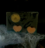 Samhain artisan soap. Grey and black swirl soap with full moon and pumpkin embeds.