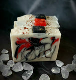 Krampus Artisan Soap. White soap with red and black swirl. Soap present on top.