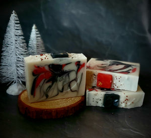 Krampus Artisan Soap. White soap with red and black swirl. Soap present on top.