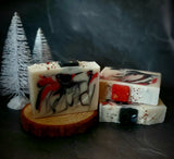 Krampus Artisan Soap. White soap with red and black swirl. Soap present on top.