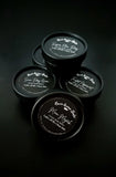 Moon Magick Body Butter. Light gray color body butter in black container.