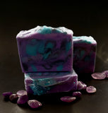 Sagittarius Astrology Soap. Purple soap with black and teal swirls. Sagittarius symbol stamped on front.