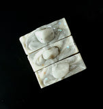 Rainbow Moonstone Soap. White soap with black and grey swirl, moonstone on top