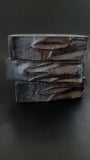 Black soap with maroon and gold accents