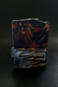 Black soap with maroon and gold accents