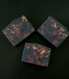 Black soap with maroon and gold accents