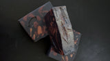 Black soap with maroon and gold accents